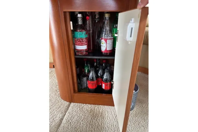  Yacht Photos Pics Bar cabinet on 2008 Silverton 38 Sport Bridge, stocked with various beverages.