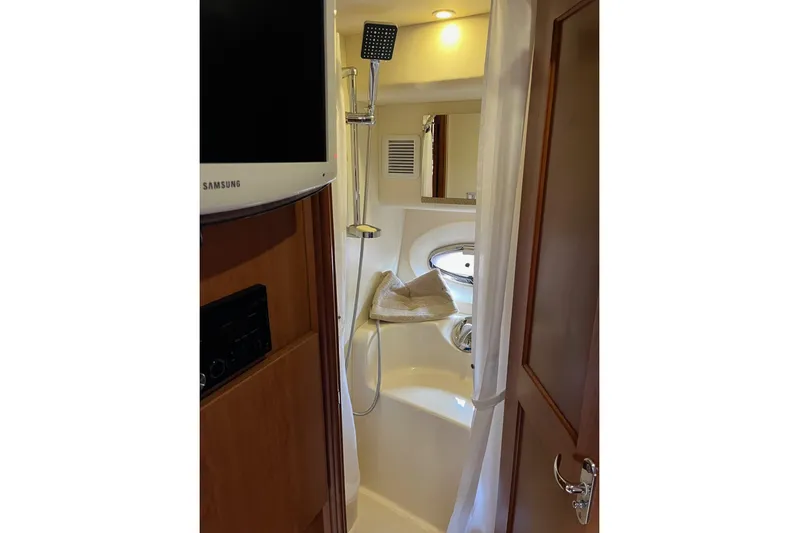  Yacht Photos Pics 2008 Silverton 38 Sport Bridge bathroom with shower, modern fixtures, and wood accents.