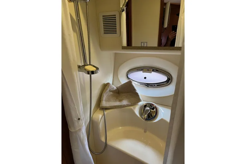  Yacht Photos Pics 2008 Silverton 38 Sport Bridge bathroom with shower, towel, and porthole window.