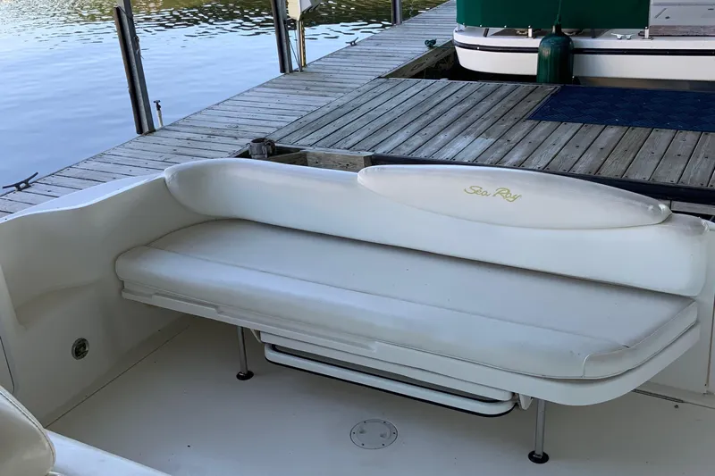 Lou Alice Yacht Photos Pics White seating area on a 2000 Sea Ray Sundancer boat docked by the water.