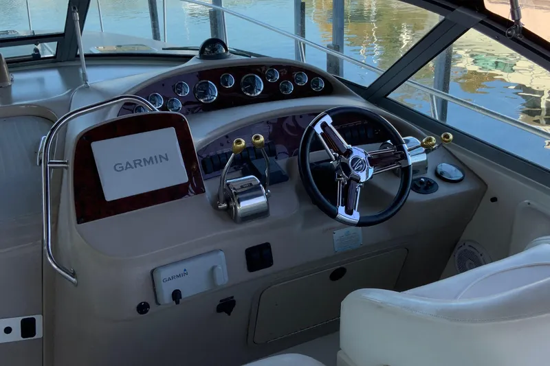 Lou Alice Yacht Photos Pics Cockpit of 2000 Sea Ray Sundancer with Garmin navigation system and steering wheel.
