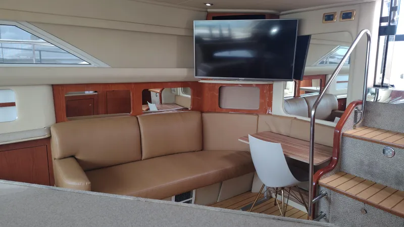 Spectre Yacht Photos Pics Luxurious interior of 2001 Sea Ray 420 Aft Cabin yacht with leather seating and TV.