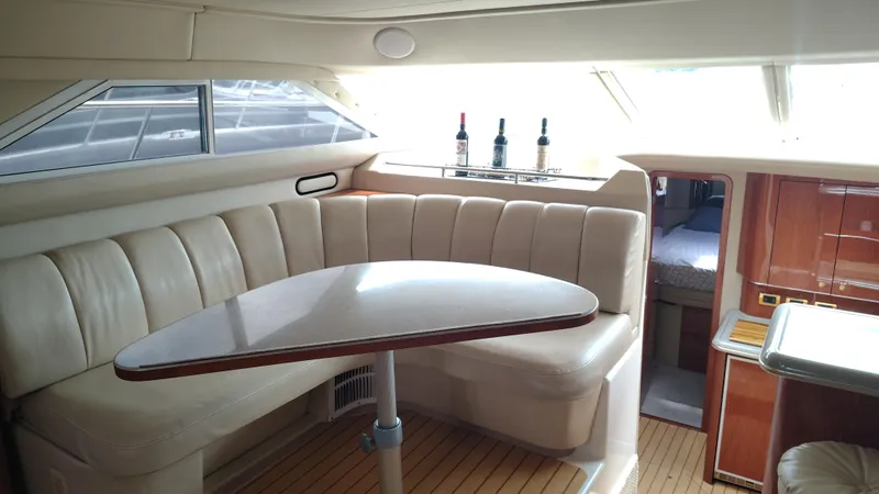 Spectre Yacht Photos Pics Luxurious interior of 2001 Sea Ray 420 Aft Cabin yacht with elegant seating and table.
