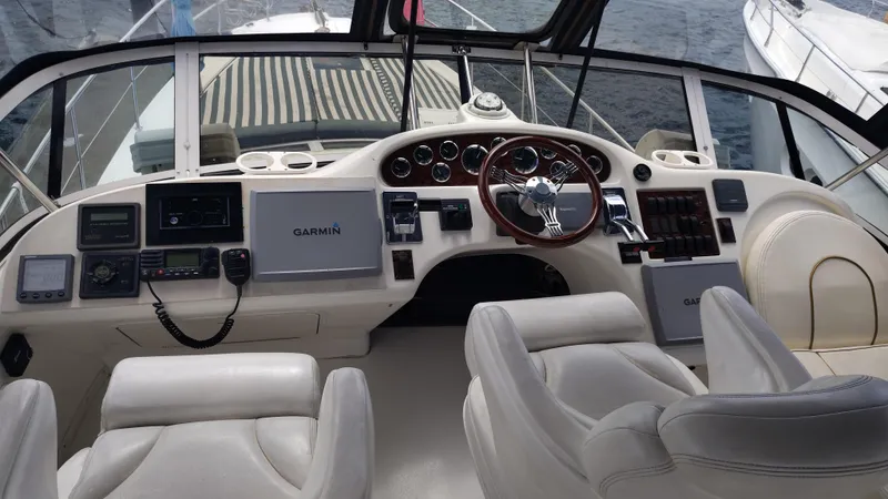 Spectre Yacht Photos Pics Helm of 2001 Sea Ray 420 Aft Cabin with Garmin navigation system and leather seating.