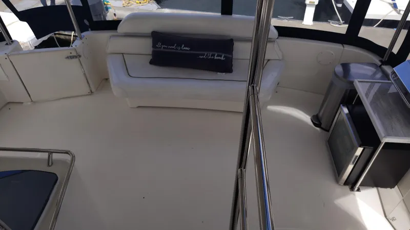 Spectre Yacht Photos Pics 2001 Sea Ray 420 Aft Cabin interior with white seating and modern amenities.