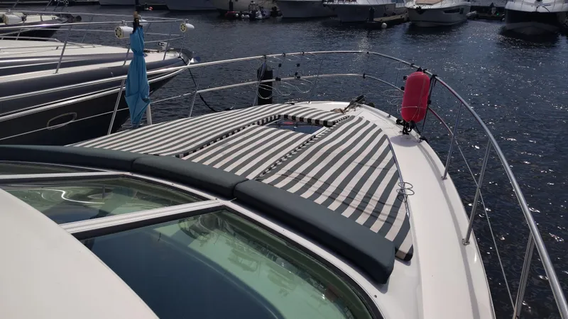 Spectre Yacht Photos Pics 2001 Sea Ray 420 Aft Cabin yacht with striped sunbathing area, docked in marina.