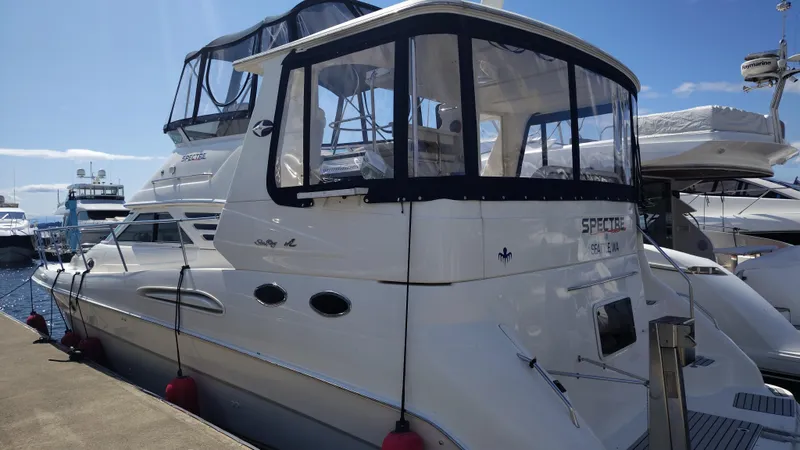 Spectre Yacht Photos Pics 2001 Sea Ray 420 Aft Cabin yacht docked at marina under clear blue sky.