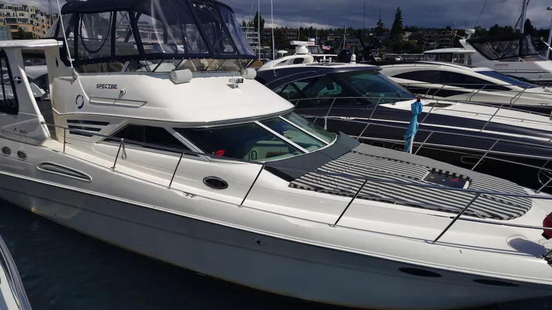 Spectre Yacht Photos Pics 2001 Sea Ray 420 Aft Cabin yacht docked at marina, side view.