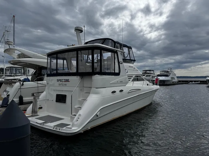 Spectre Yacht Photos Pics 2001 Sea Ray 420 Aft Cabin yacht docked in a marina under cloudy skies.