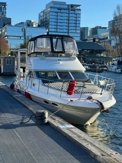 Spectre Yacht Photos Pics 2001 Sea Ray 420 Aft Cabin yacht docked in urban marina setting.