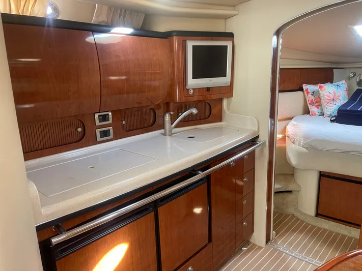  Yacht Photos Pics 2004 Sea Ray 360 Sundancer interior with kitchenette and cozy bedroom.