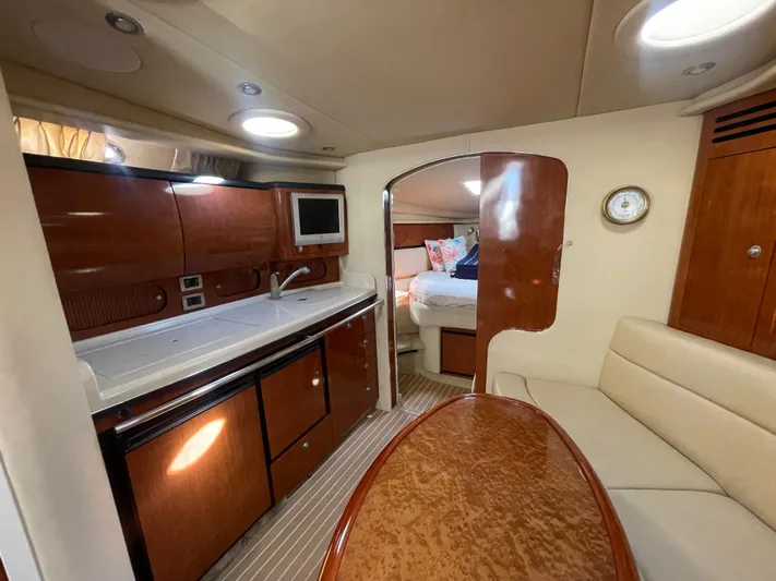  Yacht Photos Pics Interior of 2004 Sea Ray 360 Sundancer yacht with kitchen and cozy seating area.