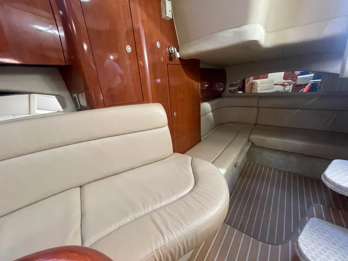  Yacht Photos Pics 2004 Sea Ray 360 Sundancer interior with beige leather seating and wooden cabinetry.