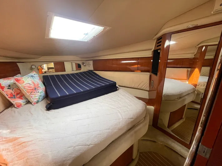  Yacht Photos Pics Luxurious cabin interior of 2004 Sea Ray 360 Sundancer with cozy bedding and floral pillows.