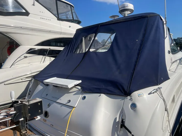  Yacht Photos Pics 2004 Sea Ray 360 Sundancer yacht with blue cover docked beside another boat.