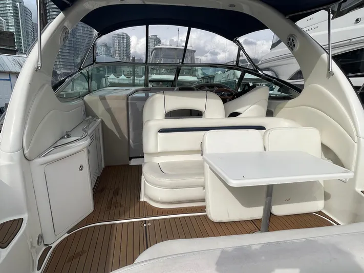  Yacht Photos Pics 2004 Sea Ray 360 Sundancer yacht interior with seating and table, docked in a marina.