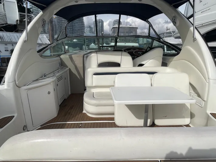  Yacht Photos Pics 2004 Sea Ray 360 Sundancer yacht interior with white seating and table, docked at marina.