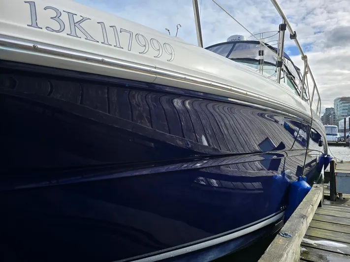  Yacht Photos Pics 2004 Sea Ray 360 Sundancer docked, showcasing sleek blue hull and registration number.