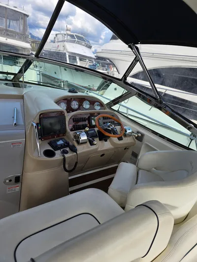  Yacht Photos Pics 2004 Sea Ray 360 Sundancer helm with leather seating and modern controls.