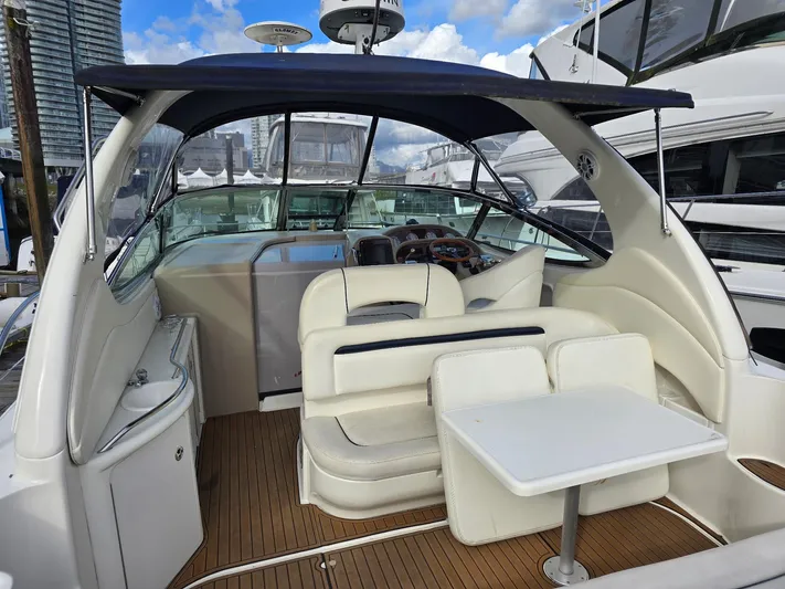  Yacht Photos Pics 2004 Sea Ray 360 Sundancer yacht interior with seating and table, docked at marina.