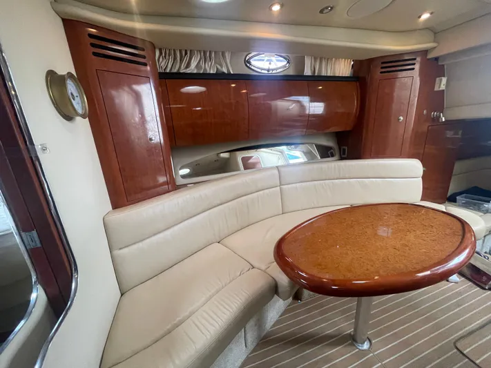  Yacht Photos Pics 2004 Sea Ray 360 Sundancer interior with beige seating and wooden table.