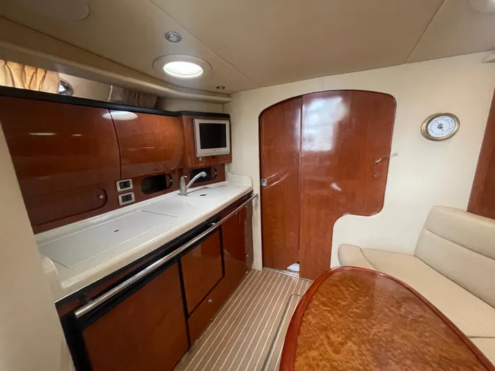  Yacht Photos Pics 2004 Sea Ray 360 Sundancer interior with kitchenette, wood cabinetry, and seating area.
