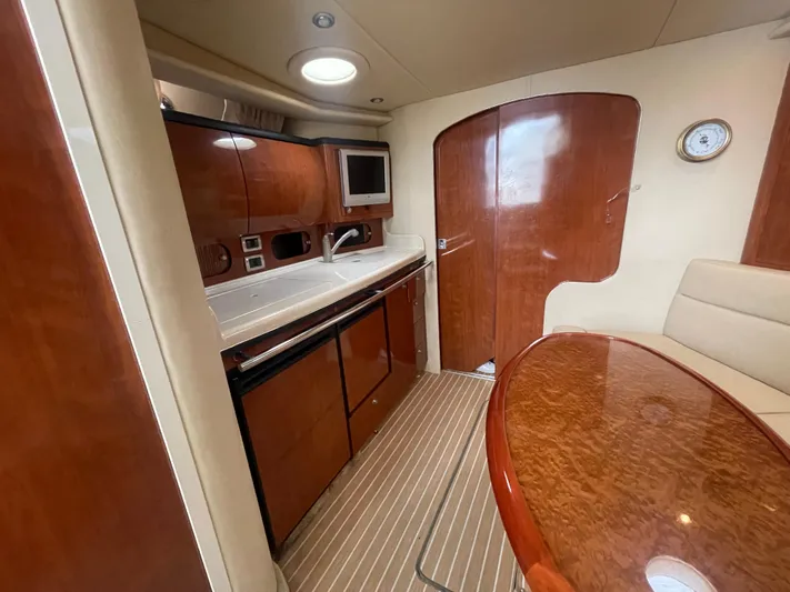  Yacht Photos Pics 2004 Sea Ray 360 Sundancer interior with wood cabinetry and dining area.