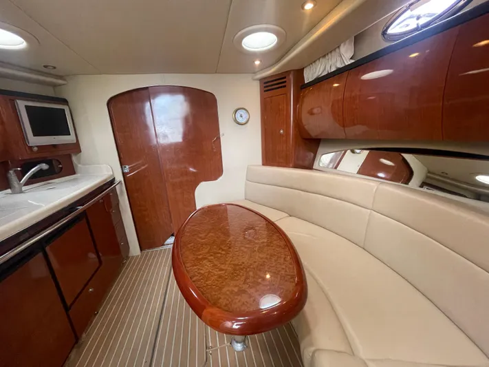  Yacht Photos Pics 2004 Sea Ray 360 Sundancer interior with kitchenette, curved seating, and wooden finishes.