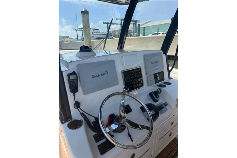  Yacht Photos Pics 2015 Cobia 344 Center Console helm with Garmin navigation system and steering wheel.