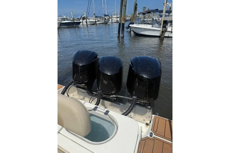  Yacht Photos Pics 2015 Cobia 344 Center Console with triple outboard engines at marina.