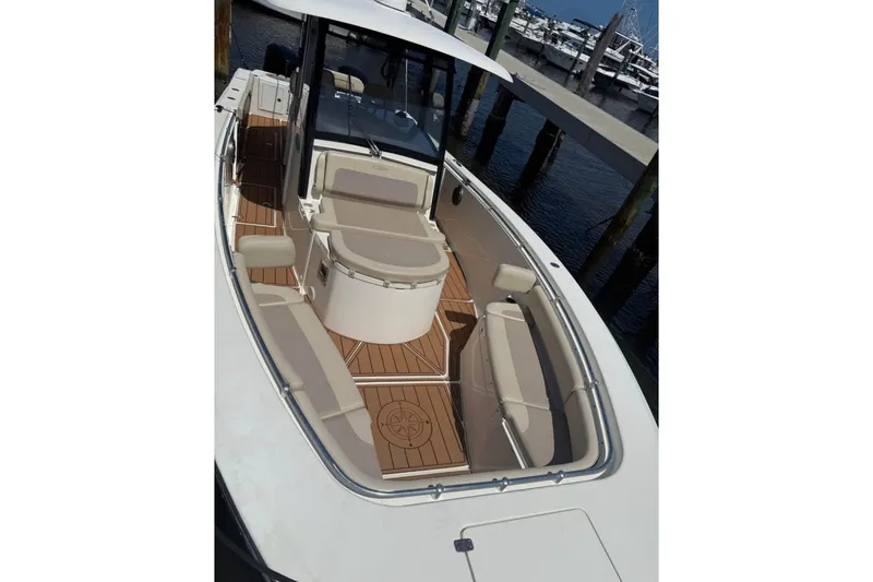  Yacht Photos Pics 2015 Cobia 344 Center Console boat with spacious deck and seating at marina.