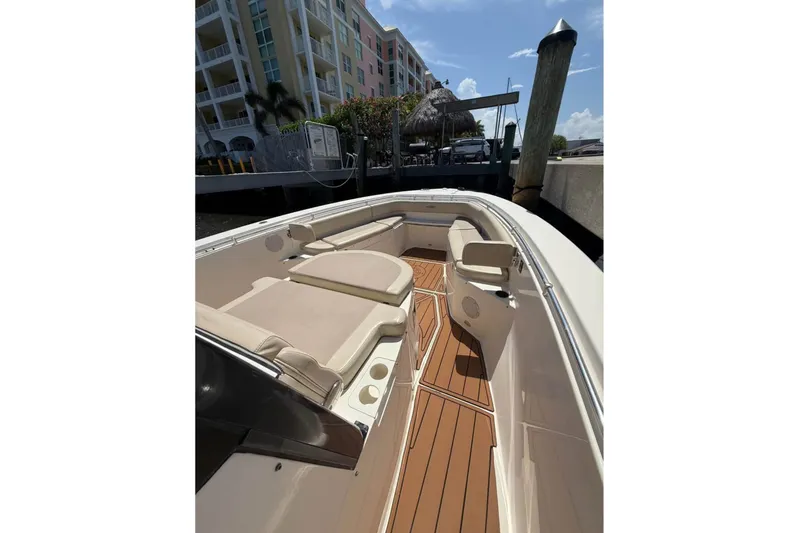 Yacht Photos Pics 2015 Cobia 344 Center Console boat docked, featuring spacious seating and teak flooring.
