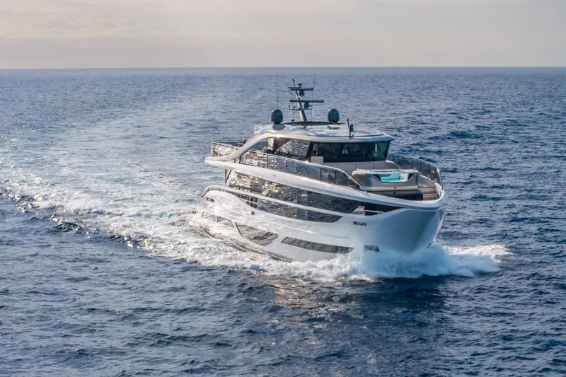 Gemini Yacht Photos Pics Luxurious 2023 Princess X95 yacht cruising on open sea, showcasing sleek design and elegance.
