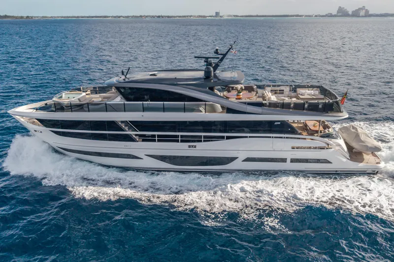 Gemini Yacht Photos Pics Luxurious 2023 Princess X95 yacht cruising on open sea, showcasing sleek design and spacious decks.
