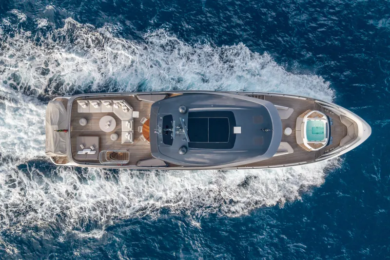 Gemini Yacht Photos Pics Aerial view of 2023 Princess X95 yacht cruising on the ocean.