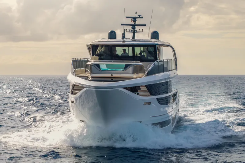 Gemini Yacht Photos Pics 2023 Princess X95 yacht cruising on open sea under cloudy sky.