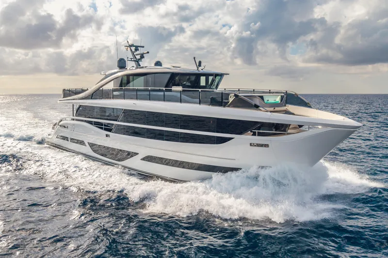 Gemini Yacht Photos Pics Luxurious 2023 Princess X95 yacht cruising on open sea under cloudy sky.