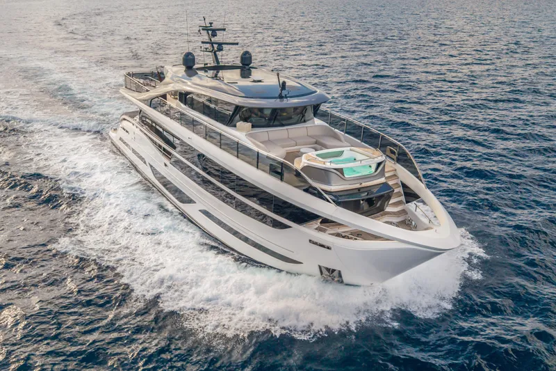Gemini Yacht Photos Pics Luxurious 2023 Princess X95 yacht cruising on open sea, showcasing sleek design and elegance.