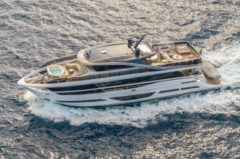 Gemini Yacht Photos Pics Luxurious 2023 Princess X95 yacht cruising on open sea, aerial view.