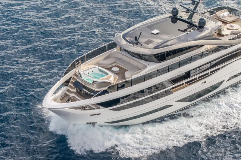 Gemini Yacht Photos Pics Luxurious 2023 Princess X95 yacht cruising on open sea with elegant design and spacious deck.