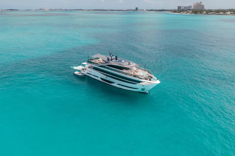 Gemini Yacht Photos Pics Luxurious 2023 Princess X95 yacht cruising in clear turquoise waters.