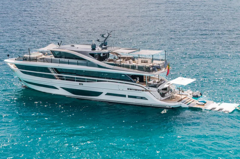 Gemini Yacht Photos Pics Luxurious 2023 Princess X95 yacht cruising on clear blue ocean waters.