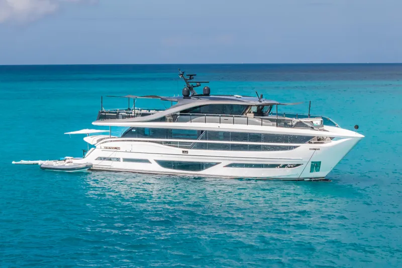 Gemini Yacht Photos Pics Luxury 2023 Princess X95 yacht on turquoise ocean waters.