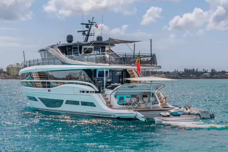 Gemini Yacht Photos Pics Luxurious 2023 Princess X95 yacht on serene blue waters, showcasing modern design and elegance.