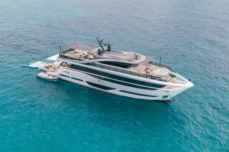 Gemini Yacht Photos Pics Luxurious 2023 Princess X95 yacht cruising on clear blue ocean waters.