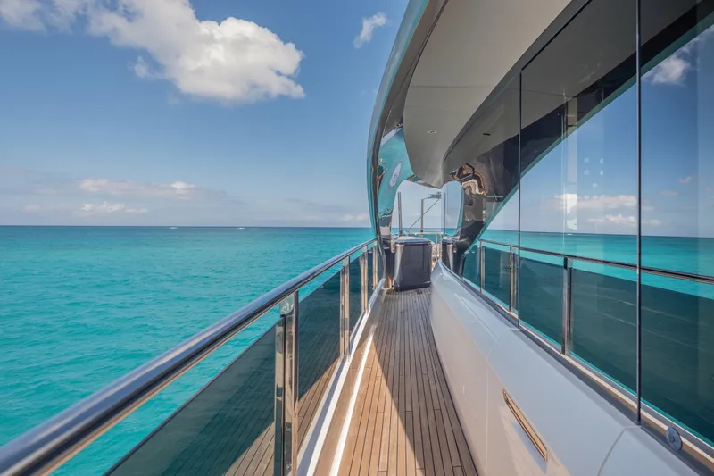 Gemini Yacht Photos Pics Luxurious 2023 Princess X95 yacht deck with ocean view and sleek design.