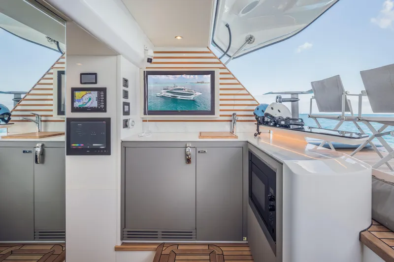 Gemini Yacht Photos Pics Luxurious 2023 Princess X95 yacht interior with modern kitchen and ocean view.