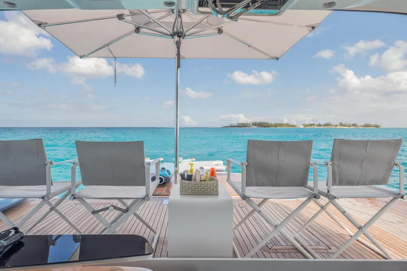 Gemini Yacht Photos Pics Luxury yacht Princess X95 deck with chairs, ocean view, and umbrella, 2023 model.