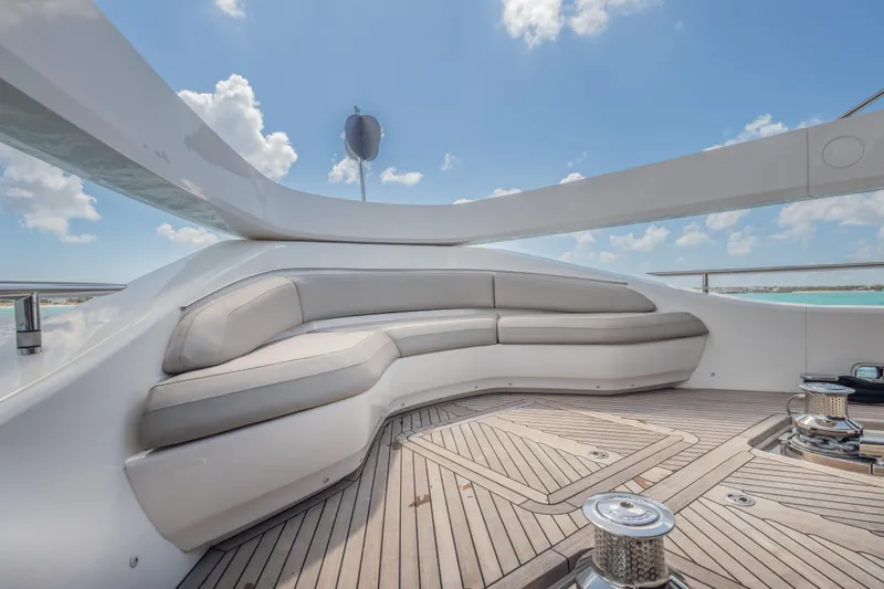 Gemini Yacht Photos Pics Luxurious seating area on 2023 Princess X95 yacht deck under clear blue sky.