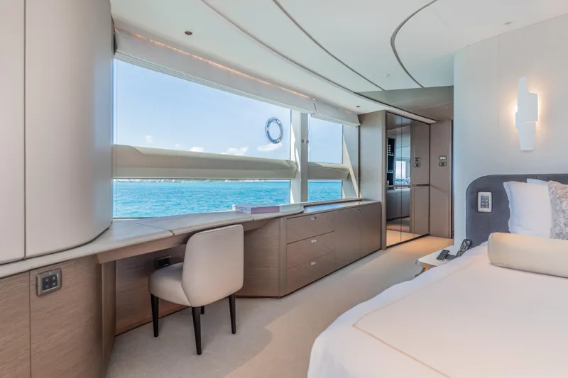 Gemini Yacht Photos Pics Luxurious 2023 Princess X95 yacht bedroom with ocean view and modern interior design.